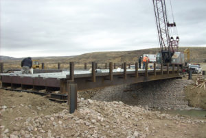 installation with crane ready to move pre-fabricated bridge design