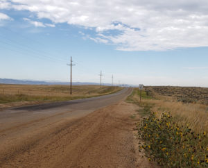 Picture of East Antelope Road with fields beside it and blue sky above