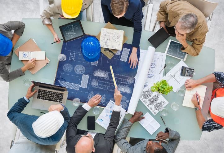 Group sitting at a conference table planning future infrastructure proejcts