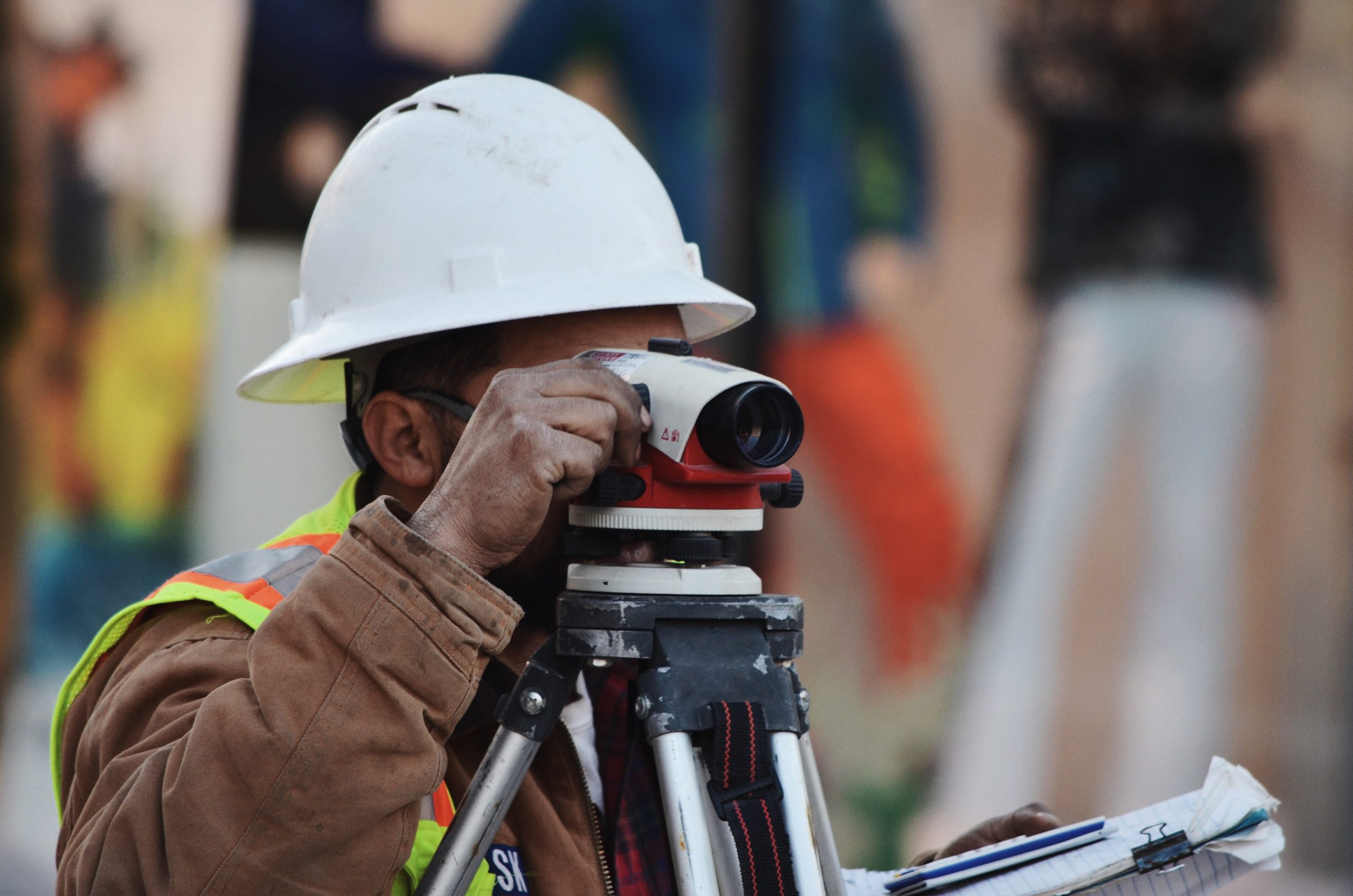 Picture of a man looking into surveying equipment